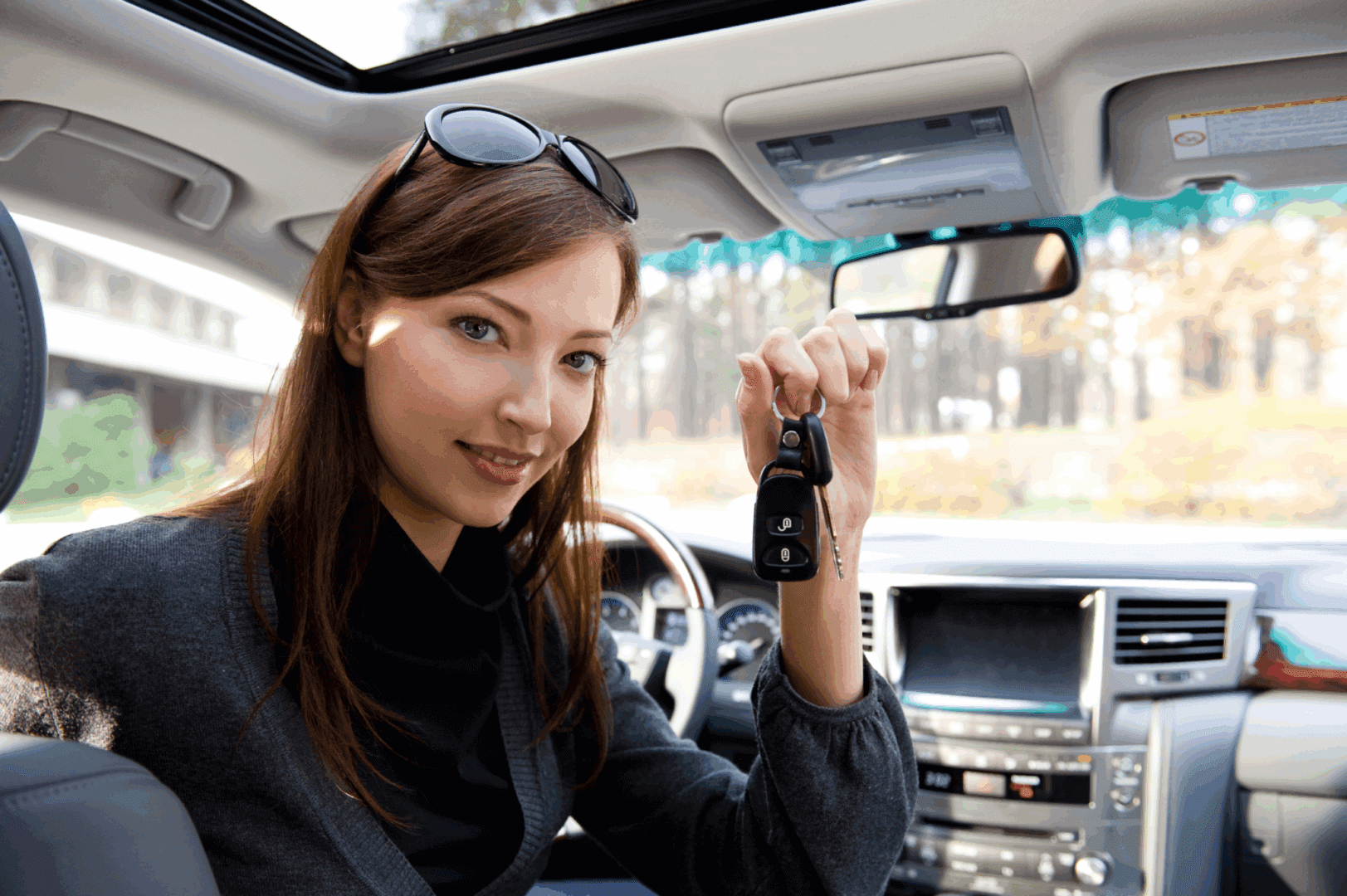 Person inside car showing ignition keys